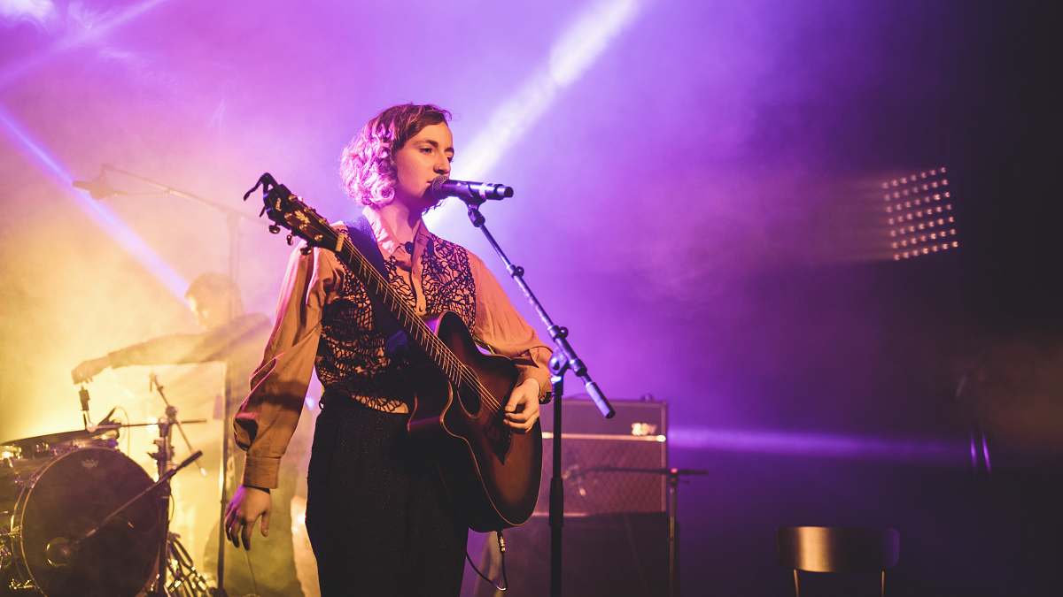 leisure activities woman playing guitar while singing musical instrument